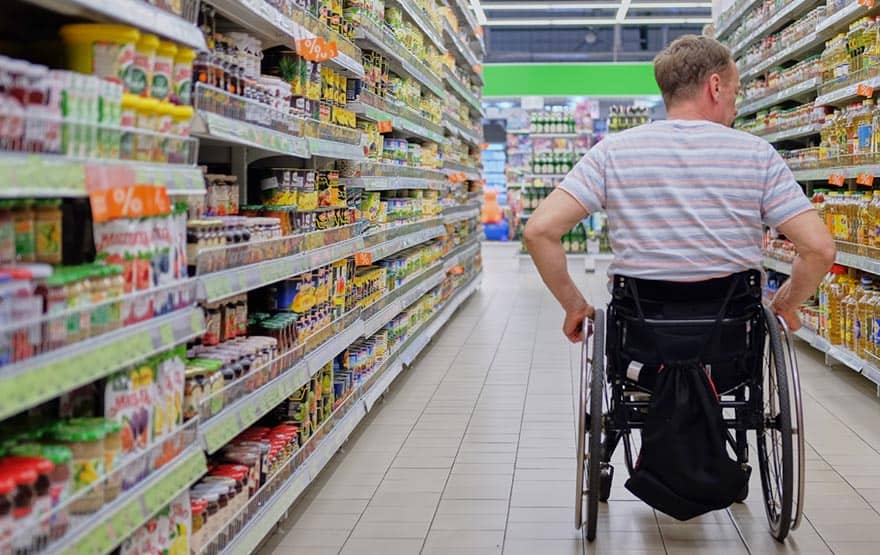 Man on wheelchair shopping